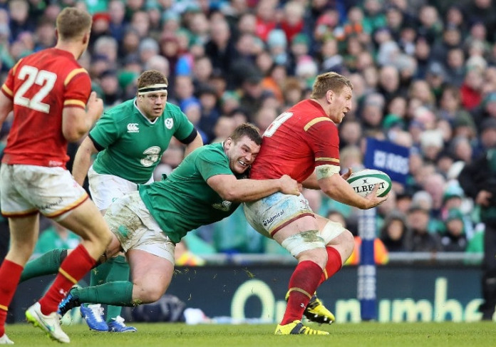 Ireland's prop Jack McGrath (L) tackles Wales' Bradley Davies during the Six Nations international rugby union match between Ireland and Wales at the Aviva Stadium in Dublin, Ireland, on February 7, 2016. / AFP / PAUL FAITH