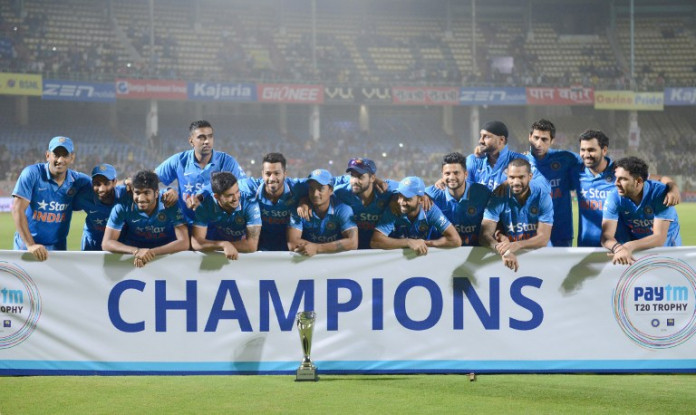 Indian cricket team pose with paytm T20 champions Trophy during the third T20 international match between India and Sri Lanka at the Dr. Y.S. Rajasekhara Reddy ACA-VDCA Cricket Stadium in Visakhapatnam on February 14, 2016. India won the series with 2-1. / AFP / NOAH SEELAM