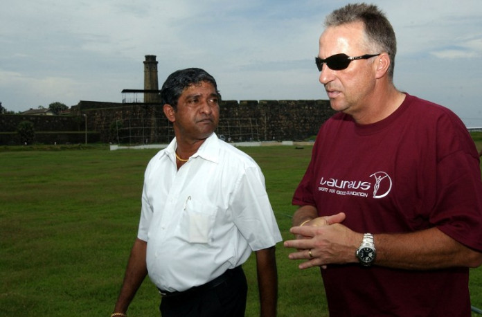 Former England cricketer Ian Botham (R) walks with stadium curator Jayananda Warnaweera at the Galle International Cricket Stadium in Galle, 20 April 2005. The stadium was submerged by the 26 December 2004 tsunamis and is not yet suitable for international matches. Botham is on a fact-finding mission to help tsunami victims and rebuild ravaged areas. AFP PHOTO/Sena VIDANAGAMA / AFP / SENA VIDANAGAMA
