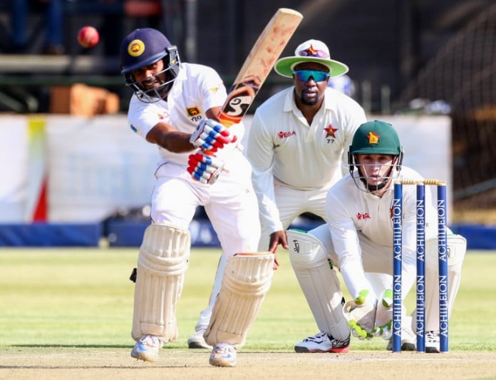 Sri Lanka batsman Kaushal Silva hits the ball as wicketkeeper Peter Moor and Tinotenda Mawoyo look on during the first cricket Test match between Sri Lanka and hosts Zimbabwe at the Harare Sports Club, on October 29, 2016.