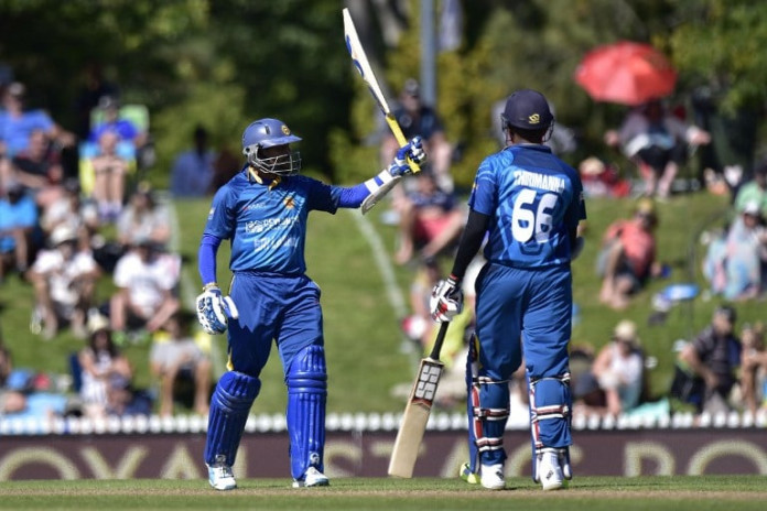 Tillakaratne Dilshan (L) of Sri Lanka celebrates 50 runs with teammate Lahiru Thirimanne during the 3rd One Day International cricket match between New Zealand and Sri Lanka at Saxton Oval in Nelson on December 31, 2015. AFP PHOTO / MARTY MELVILLE / AFP / Marty Melville