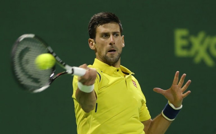 TENNIS-ATP-QAT Novak Djokovic of Serbia returns the ball to Rafael Nadal of Spain during the final of the Qatar Open tennis tournament on January 9, 2016, in Doha. Djokovic won his 60th ATP title with his crushing 6-1, 6-2 triumph over Nadal in the Qatar Open final to move into the all-time top 10. AFP PHOTO / KARIM JAAFAR / AFP / KARIM JAAFAR