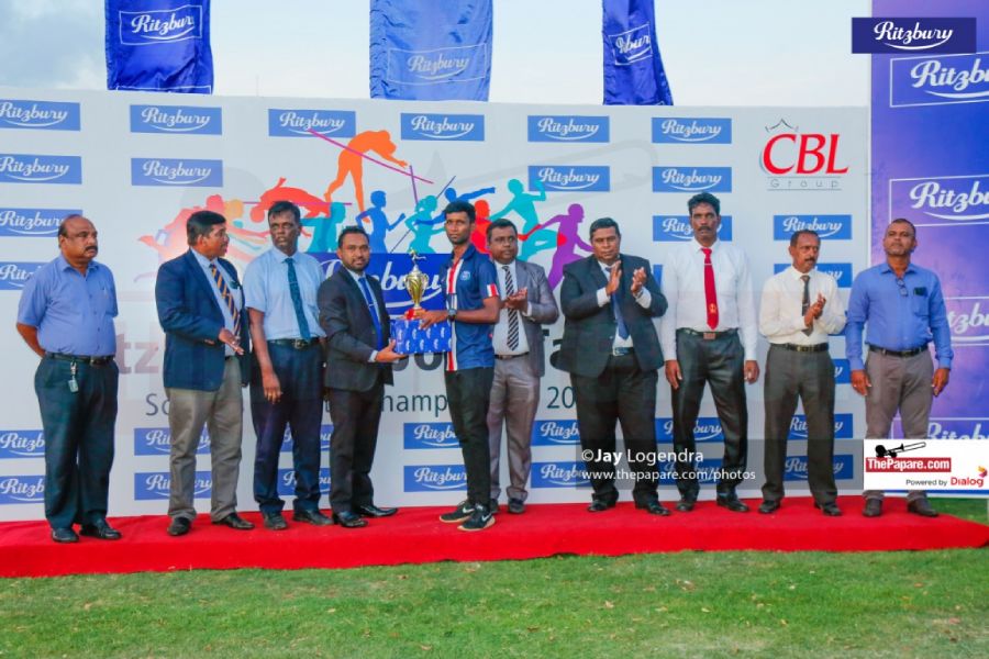 Aruna Liyanapathirana, Category Manager – Ritzbury, presents the overall boys championship trophy to Pallai Central College