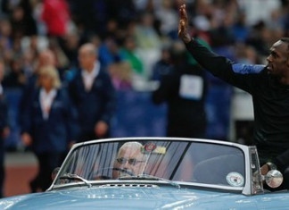 Usain Bolt was driven around the track on the back of a convertible sportscar as he was introduced to the crowd at the start of the evening