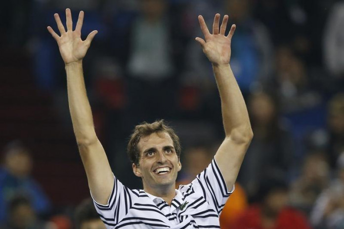 Albert Ramos-Vinolas of Spain celebrates winning his men's singles tennis match against Roger Federer of Switzerland at the Shanghai Masters tennis tournament in Shanghai