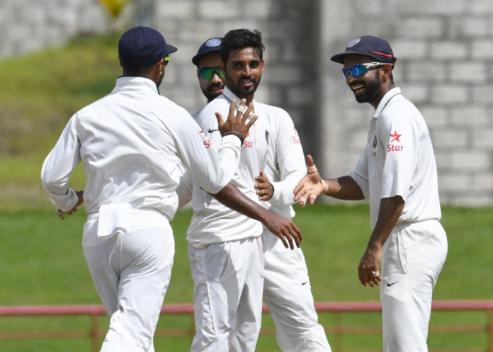 Bhuvneshwar Kumar (C) celebrates with Ajinkya Rahane (R) of India taking 5 West Indies wickets for 33 runs during day 4 of the 3rd Test between West Indies and India on August 12, 2016 at Darren Sammy National Cricket Stadium Gros Islet, St. Lucia. / AFP / Randy BROOKS (Photo credit should read RANDY BROOKS/AFP/Getty Images)