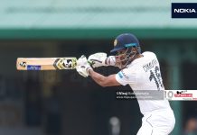 Karunaratne stands tall on rain-curtailed day