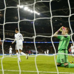 CSKA Moscow's Igor Akinfeev looks dejected after scoring a own goal and the third for Tottenham as Tottenham's Dele Alli celebrates