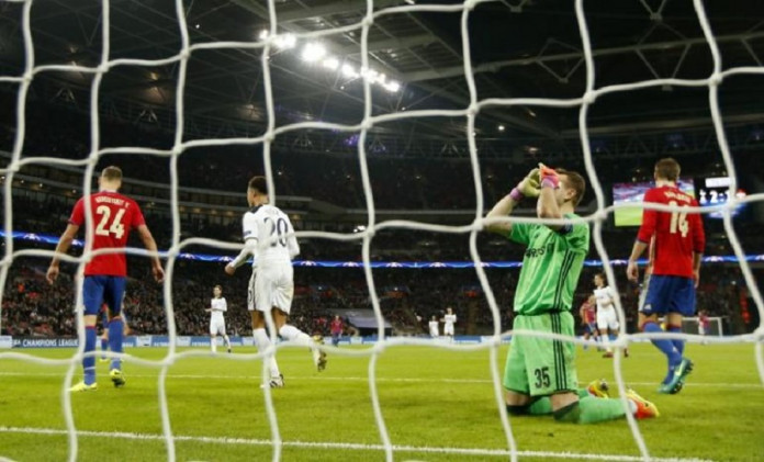 CSKA Moscow's Igor Akinfeev looks dejected after scoring a own goal and the third for Tottenham as Tottenham's Dele Alli celebrates