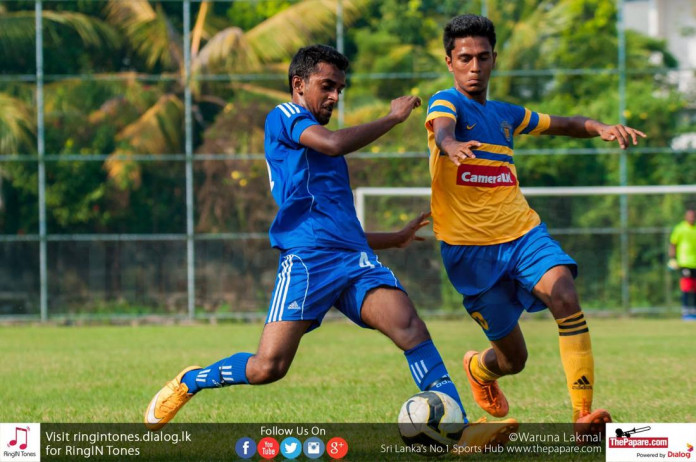 Ratnam SC player (L) and a Kirulapone United player tussling for the ball in the FA Cup 5th Round match