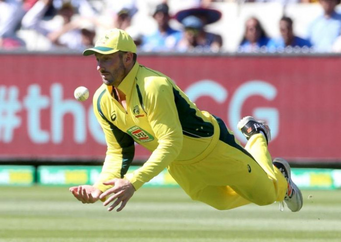 Australia's Shaun Marsh dives to collect a skied shot from India's Virat Kohli on the first bounce during their One Day cricket match at the Melbourne Cricket Ground