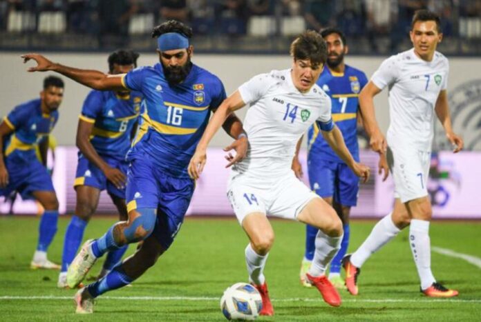 Sri Lanka’s Chamod Dilshan (L) & Uzbekistan’s captain Eldor Shomurodov (R) tussling for the ball in their AFC Asian Cup qualifiers 2023 – 3rd Round match