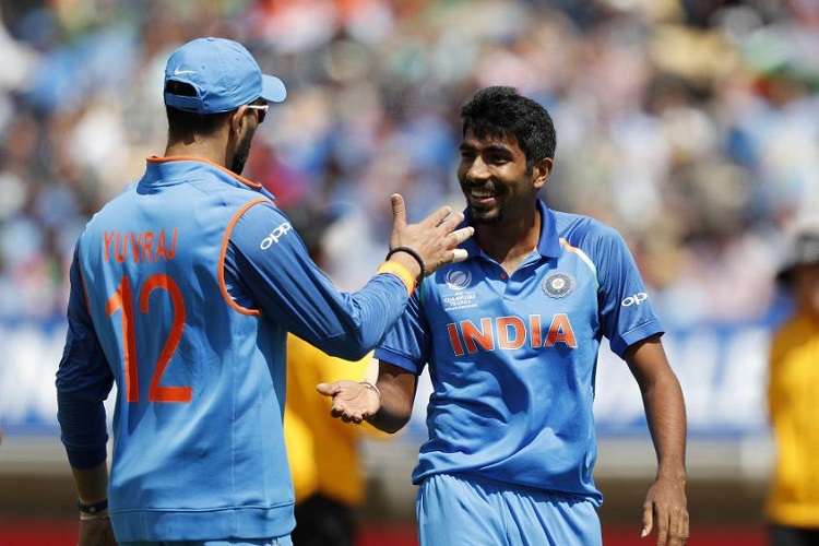 Jasprit Bumrah celebrates with Yuvraj Singh after taking the wicket of Mosaddek Hossain.