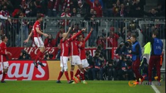 Bayern Munich's Thiago Alcantara celebrates scoring their third goal with teammates