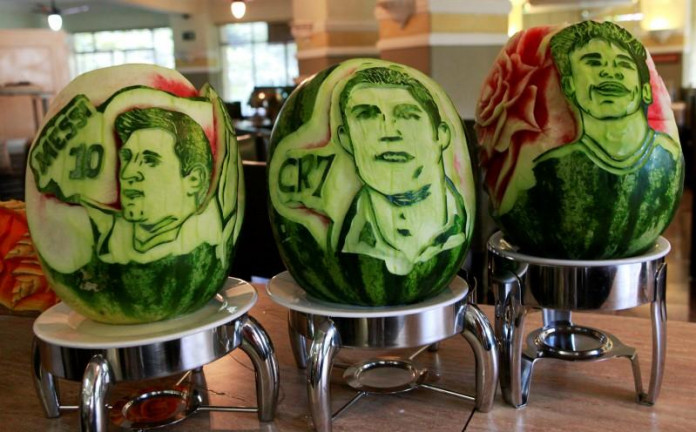 Watermelons with the carvings of (L to R) Argentina's Lionel Messi, Portugal's Cristiano Ronaldo and Brazil's Neymar are seen at San Raphael hotel in Sao Paulo May 7, 2014. REUTERS/Paulo Whitaker