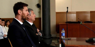 Barcelona's Argentine soccer player Lionel Messi sits in court with his father Jorge Horacio Messi during their trial for tax fraud in Barcelona