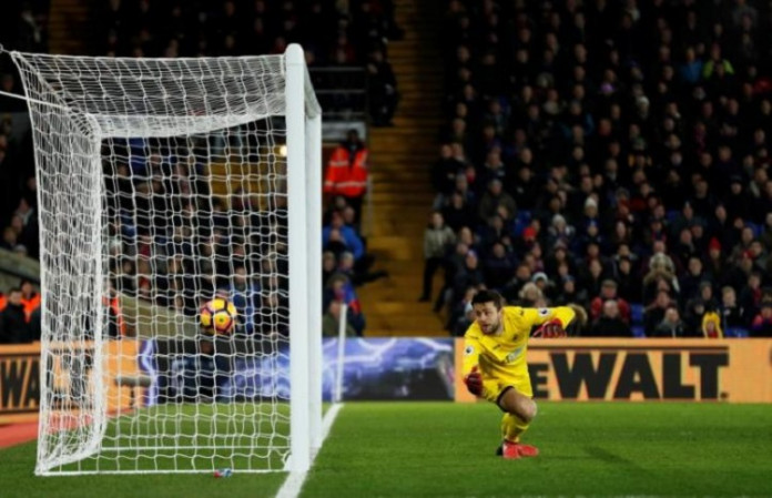 Crystal Palace's Wilfried Zaha scores their first goal as Swansea City's Lukasz Fabianski attempts save