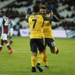 Arsenal's Alexis Sanchez celebrates scoring their fifth goal to complete his hat trick with Alex Oxlade-Chamberlain