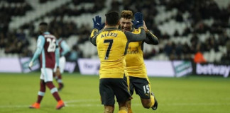 Arsenal's Alexis Sanchez celebrates scoring their fifth goal to complete his hat trick with Alex Oxlade-Chamberlain