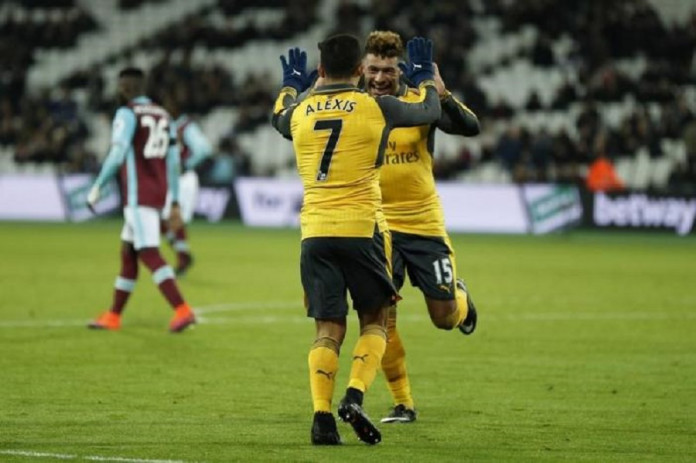 Arsenal's Alexis Sanchez celebrates scoring their fifth goal to complete his hat trick with Alex Oxlade-Chamberlain