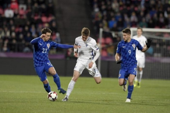 inland's Janne Saksela, Croatia's Josip Pivaric and Andrej Kramaric in action during the FIFA World Cup 2018 football qualification match between Finland and Croatia in Tampere