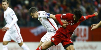 Robert Lewandowski struck in the fifth minute of stoppage time to give Poland a dramatic 2-1 home win over 10-man Armenia in a World Cup Group E qualifier on Tuesday.