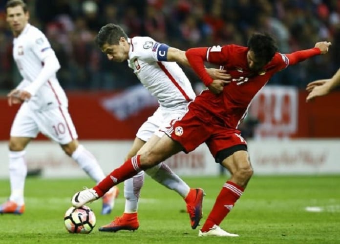 Robert Lewandowski struck in the fifth minute of stoppage time to give Poland a dramatic 2-1 home win over 10-man Armenia in a World Cup Group E qualifier on Tuesday.