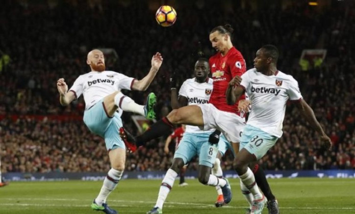 Manchester United's Zlatan Ibrahimovic in action with West Ham United's James Collins and Michail Antonio