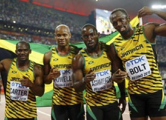 Jamaica's team Nesta Carter, Asafa Powell, Nickel Ashmeade and Usain Bolt pose for photographers after winning the men's 4 x 100 metres relay final during the 15th IAAF World Championships at the National Stadium in Beijing
