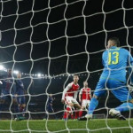 Arsenal's Alex Iwobi scores an own goal and the second goal for Paris Saint-Germain