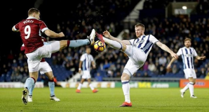 Burnley's Sam Vokes in action with West Bromwich Albion's Chris Brunt